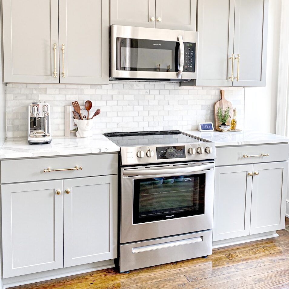 white microwave oven on white wooden cabinet