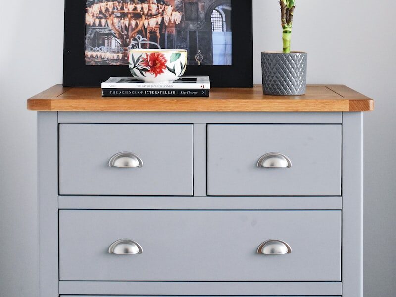 framed photo on wooden dresser with potted plant