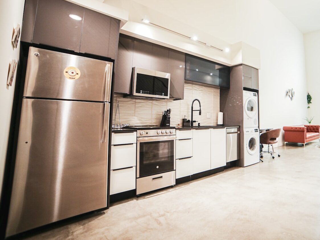 brown wooden kitchen cabinet near white wall