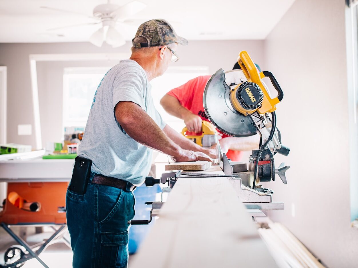 man standing infront of miter saw