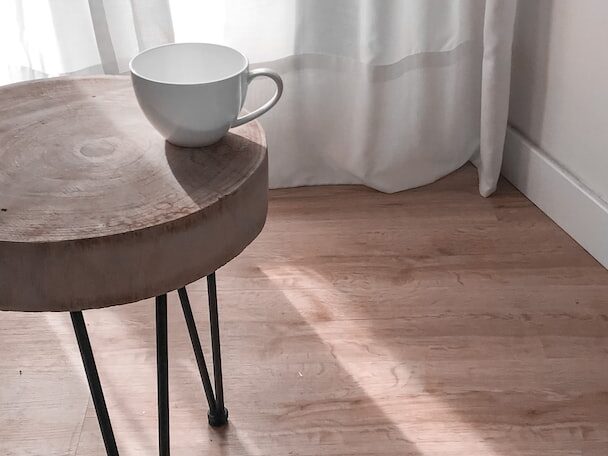 white ceramic mug on brown wooden table